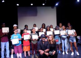 Tina's Angels and Richard's Warriors pose in a group and holding awards