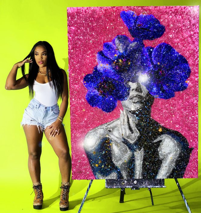 Tiffanie Anderson posing by her artwork