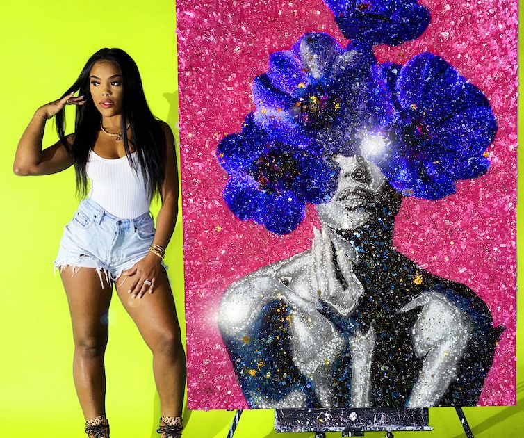 Tiffanie Anderson posing by her artwork